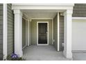 Inviting front porch with white columns and security system at 204 Cozy Brook Ct, Summerville, SC 29486