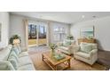 Bright living room with sliding glass doors to the backyard and neutral decor at 204 Cozy Brook Ct, Summerville, SC 29486
