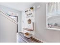 Bright entryway with wood floors, coat rack and decor with natural light from a window at 212 Goshen Rd, Moncks Corner, SC 29461