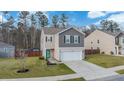 Inviting two-story home featuring a well-kept lawn, neutral siding, attached garage, and modern curb appeal at 212 Goshen Rd, Moncks Corner, SC 29461