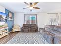 Cozy living room featuring modern furnishings, a ceiling fan, and a large window with natural light at 212 Goshen Rd, Moncks Corner, SC 29461