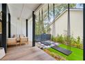 Relaxing porch with porch swings, chairs, and an artificial grass yard at 2166 Welch Ave, Charleston, SC 29412