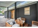 Charming front porch with chairs, a wood deck, and a view of the yard at 2166 Welch Ave, Charleston, SC 29412