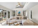 Comfortable living area featuring a large sectional sofa, stylish pillows, and sliding doors to the outdoor deck at 2276 Seascape Ct, Seabrook Island, SC 29455