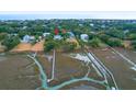 Aerial view of waterfront property showcasing neighborhood and surrounding landscape at 2820 Jasper Blvd, Sullivans Island, SC 29482