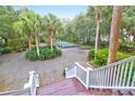 Private backyard featuring a sparkling pool, patio and mature trees at 2820 Jasper Blvd, Sullivans Island, SC 29482