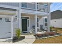 Inviting front porch with chairs, detailed trim, and a neatly landscaped yard at 2905 Cavalcade Cir, Johns Island, SC 29455