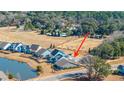A captivating aerial view showcases a beautiful house with a serene pond nearby at 292 Lotz Dr, Summerville, SC 29483