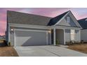 Attractive single-Gathering house with a neat lawn, convenient driveway, and attached garage at 302 Autumn Azalea Way, Summerville, SC 29486