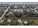 Aerial view of coastal neighborhood showcasing beach access and neatly arranged homes along the coastline at 308 Jungle Rd, Edisto Beach, SC 29438
