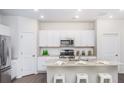 Modern kitchen boasts stainless steel appliances, granite countertops, and a convenient center island at 317 Pine Crest View, Summerville, SC 29486