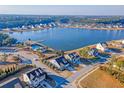 Aerial view of a lakeside neighborhood featuring lush landscaping, community pool, and scenic walking trails at 3278 Great Egret Dr, Johns Island, SC 29455
