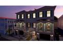 Beautiful new construction townhomes with green shutters, private garages, and inviting front yard at 4 Trapman St # B, Charleston, SC 29401