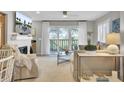 Bright living room featuring a cozy fireplace, large windows, and comfortable seating at 409 Yacht Harbor Ct # 409, Isle of Palms, SC 29451