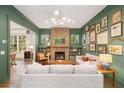 Inviting living room with a brick fireplace, stylish decor, and plenty of natural light at 493 Woodland Shores Rd, Charleston, SC 29412