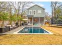 Relaxing backyard with a pool, patio furniture, and privacy fence, perfect for outdoor enjoyment at 493 Woodland Shores Rd, Charleston, SC 29412