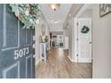 Bright entryway with wood flooring, decorated door, and view to an open floor plan at 5073 Blair Rd, Summerville, SC 29483