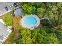 Aerial view of the community pool, hot tub, lounge chairs, and mature landscaping at 60 Fenwick Hall Allee # 521, Johns Island, SC 29455