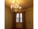 Dining area with a gold chandelier, hardwood floors, and natural light from window at 668 Rutledge Ave, Charleston, SC 29403