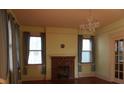 Traditional living room featuring a brick fireplace, hardwood floors, and an elegant chandelier at 668 Rutledge Ave, Charleston, SC 29403