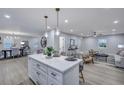 Open-concept kitchen with island seating seamlessly connecting to dining and living areas at 828 Longbranch Dr, Charleston, SC 29414