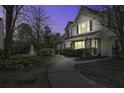Exterior of well maintained townhouse at dusk overlooking a pond with fountain at 901 Elm Hall Cir, Summerville, SC 29483