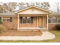 Close up of the home's front door, showcasing the brick facade and porch at 105 Pinewood St, Walterboro, SC 29488