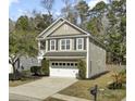 View of a two-story home featuring neutral siding, white trim, and a two-car garage at 110 Instructor Ct, Ladson, SC 29456