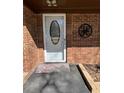 Elegant glass front door featuring a detailed monogram on the brick exterior at 111 Newington Rd, Summerville, SC 29485