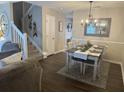 Cozy dining room featuring wood floors, an elegant chandelier, and a dining table set for four at 120 Hornby Cir, Goose Creek, SC 29445