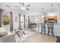 Open-concept space with a spacious living room, dining area, and kitchen with bar stool seating at 1225 Blakeway St # 403, Charleston, SC 29492