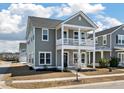 Beautiful two-story home with a charming front porch and gray siding at 127 Country Gate Ln, Summerville, SC 29485