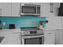 Stainless steel range with microwave and custom backsplash at 1300 Ocean Blvd # 238, Isle of Palms, SC 29451