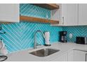 Close up of the kitchen sink area with white countertop and accent backsplash at 1300 Ocean Blvd # 238, Isle of Palms, SC 29451