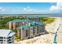 Enjoy beautiful views from this oceanfront condo with private beach access and lush landscaping at 1401 Ocean Club Dr, Isle of Palms, SC 29451