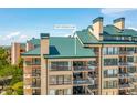 Close exterior of condo with balconies overlooking trees and views at 1401 Ocean Club Dr, Isle of Palms, SC 29451