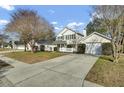Lovely home with a quaint front porch, white picket fence, and attached garage with long driveway at 147 Moon Dance Ln, Summerville, SC 29483