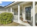 Cozy front porch with rocking chairs and stylish front door with sidelight at 147 Moon Dance Ln, Summerville, SC 29483