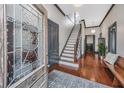 Inviting foyer with hardwood floors, decorative glass front door and staircase at 207 S Gum St, Summerville, SC 29483