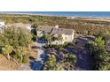 Aerial view of a coastal home nestled among lush greenery, offering privacy and serenity at 2238 Catesbys Blf, Seabrook Island, SC 29455