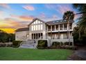 Expansive two-story home featuring multiple balconies and a well-manicured lawn at 2238 Catesbys Blf, Seabrook Island, SC 29455