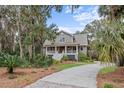 Charming two-story home with a welcoming front porch and beautifully landscaped front yard at 2648 Seabrook Island Rd, Seabrook Island, SC 29455