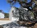 Two-story home with gray siding, white trim, attached garage, and concrete driveway at 343 Wappoo Rd, Charleston, SC 29407