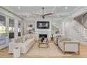 Inviting living room with custom built-ins, a cozy fireplace, and hardwood flooring at 3699 Goodwater St, Mount Pleasant, SC 29466
