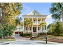 Charming two-story home with double porches, mature palm trees, and a two-car garage at 388 Evian Way, Mount Pleasant, SC 29464