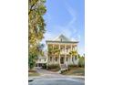 Beautiful two-story home with double porches, palm trees, well-kept landscaping, and a detached garage at 388 Evian Way, Mount Pleasant, SC 29464