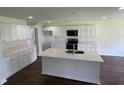 Kitchen featuring an island with sink and plenty of cabinets for storage at 4804 Coopers Ct, Summerville, SC 29485