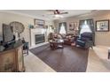 Comfortable living room featuring a fireplace, plush seating, and elegant decor, creating a warm and inviting atmosphere at 4869 Habersham Ln, Summerville, SC 29485