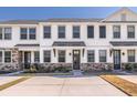 Charming townhouse with stone accents, light trim, and black door awning at 5146 Park Creek Ave, North Charleston, SC 29418