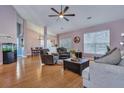 Bright living room boasting hardwood floors, comfortable seating, and an open layout to the dining area at 5420 Percival Ln, North Charleston, SC 29420